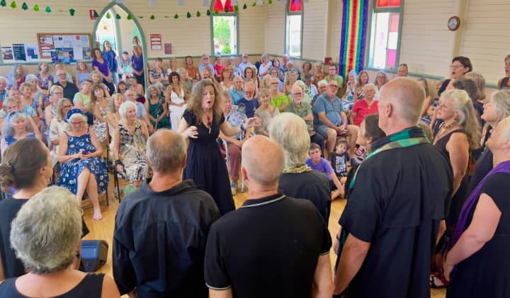 WolfSong Voices choir performing on stage at a Northern Rivers community concert