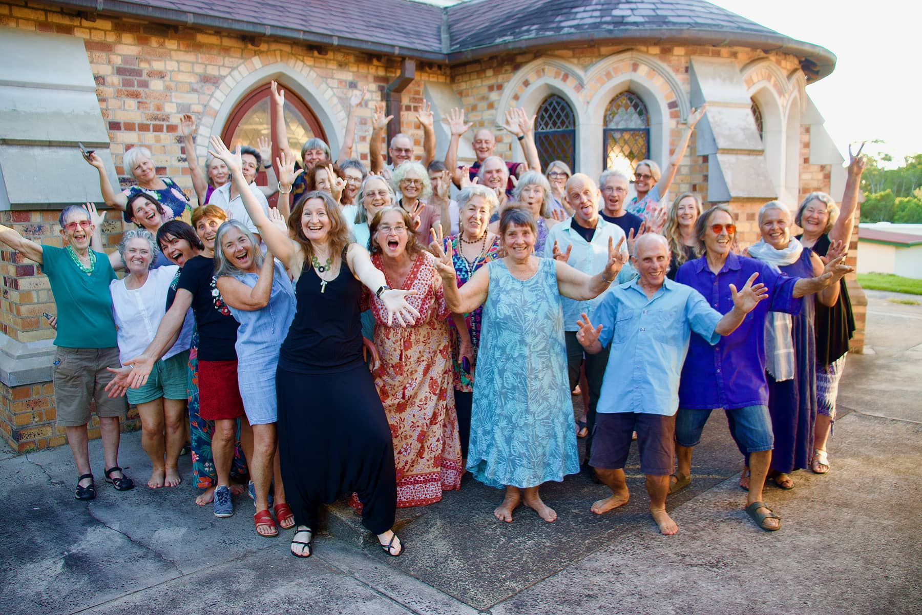 All In A Chord community choir fun posed group photo outside St Andrews Church in Lismore, where they rehearse