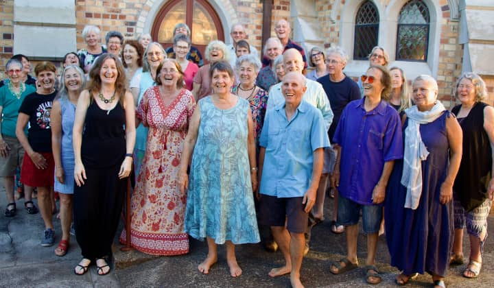 All In A Chord community choir fun posed group photo outside St Andrews Church in Lismore, where they rehearse