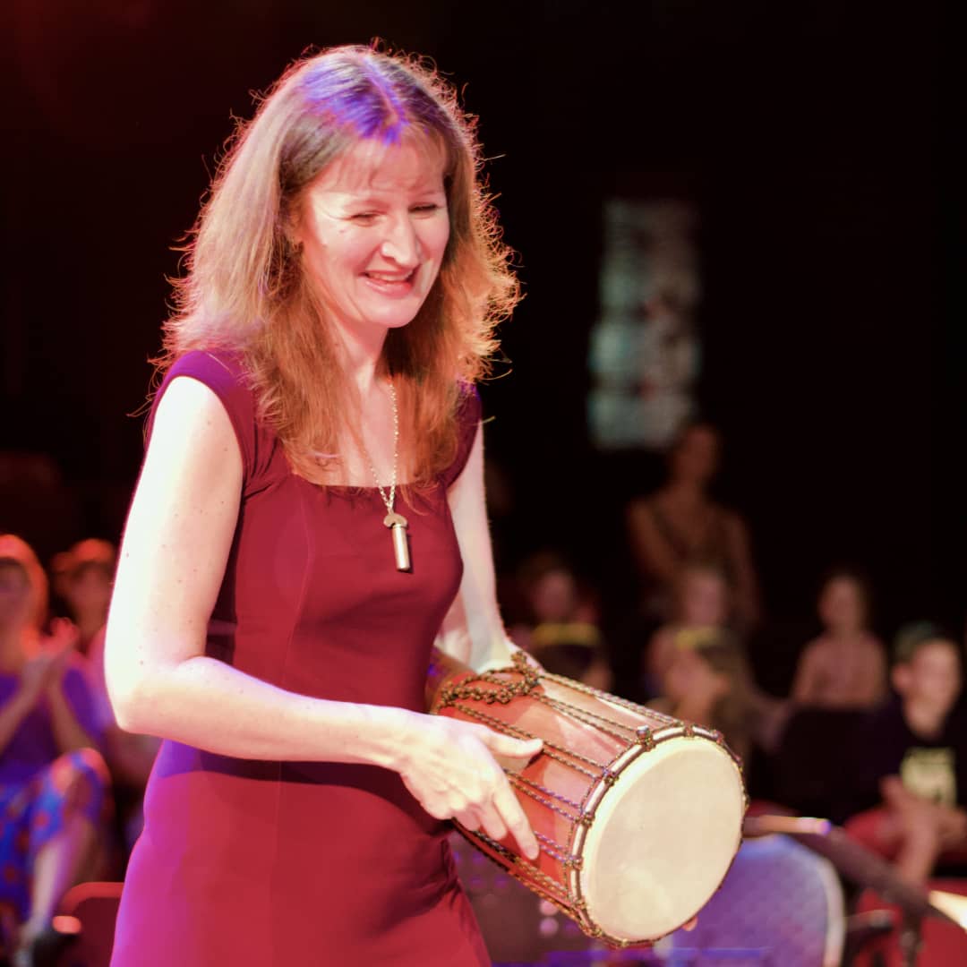 Imogen Wolf playing percussion during WolfSong choir concert at Byron Bay Theatre