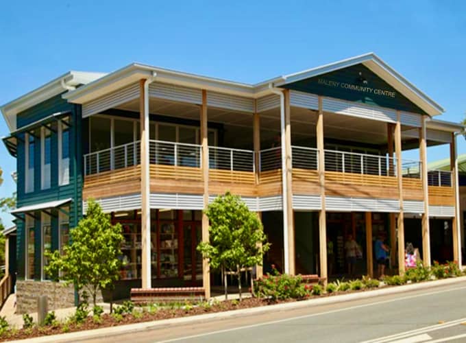 Two-storey timber and steel Maleny Community Centre building viewed from the street on a clear day