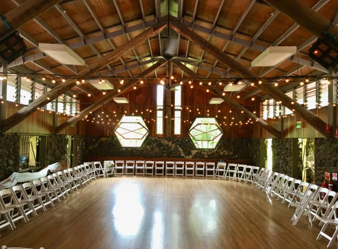 Interior of Hanging Rock Hall with beautiful natural timber construction and string lights set up for a singing circle